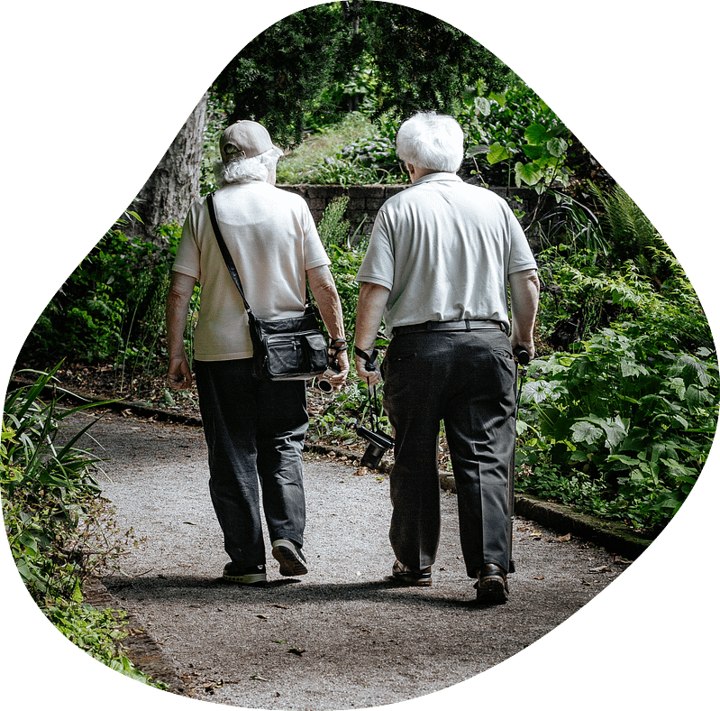 elderly couple walking on path with affordable whole life plan